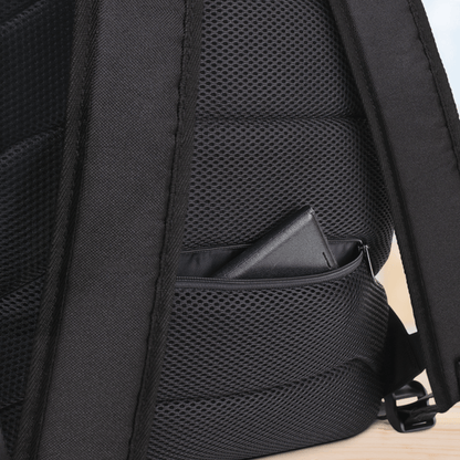 Close-up of the back side of a backpack with mesh design on a light wood surface.