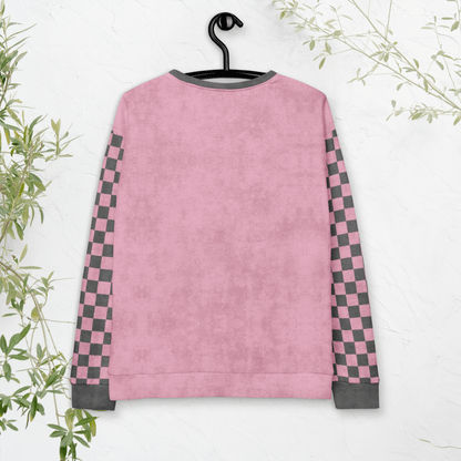 Pink sweatshirt with checkered sleeves on a hanger against a white background