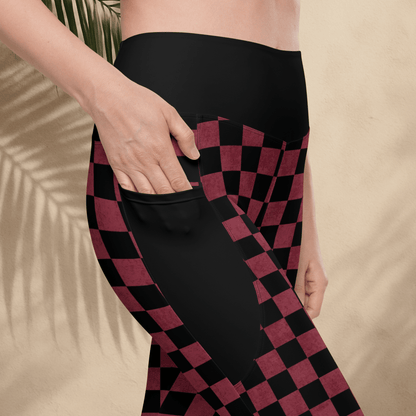 Person wearing black and burgundy checkered leggings on a beige background