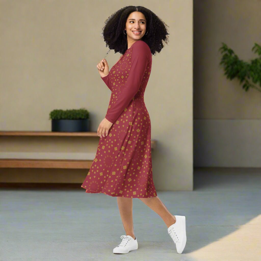 Woman wearing a burgundy boho dress with a subtle pattern on a neutral background