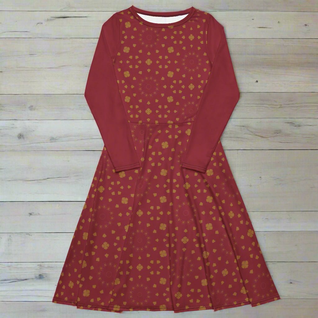 Burgundy dress with gold pattern on a wood background