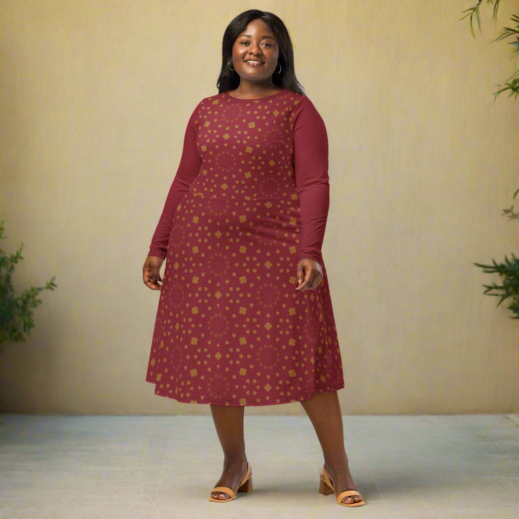 Woman wearing a burgundy boho patterned dress on a neutral background