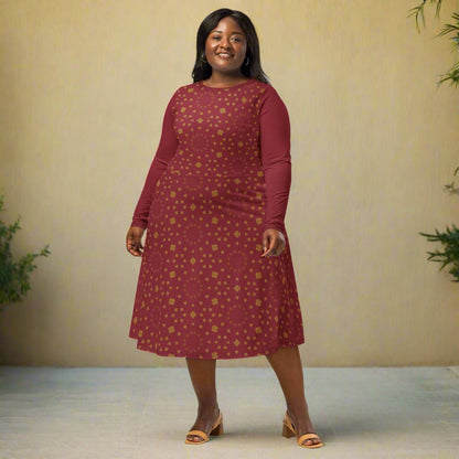 Woman wearing a burgundy boho patterned dress on a neutral background