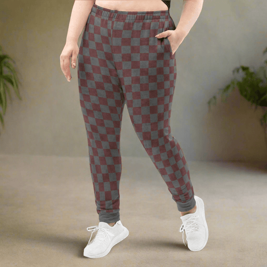 Person wearing checkered pants with a neutral background