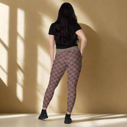 Person wearing checkered leggings on a neutral background