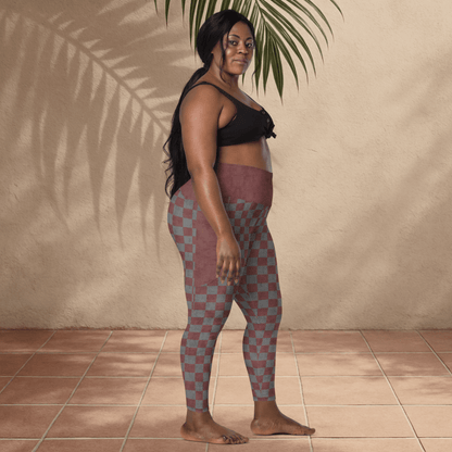 Woman wearing checkered leggings and a black top against a beige wall.