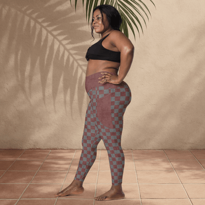 Woman wearing checkered leggings and black sports bra against a beige wall.
