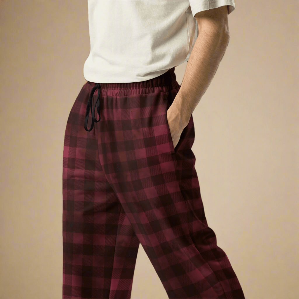 Red plaid pajama pants worn by a person on a beige background