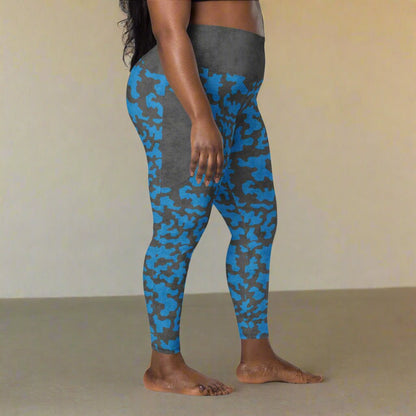 Person wearing blue and gray camouflage leggings on a neutral background