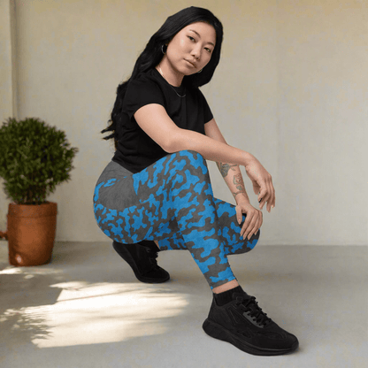 Person wearing blue and gray patterned leggings on a neutral background