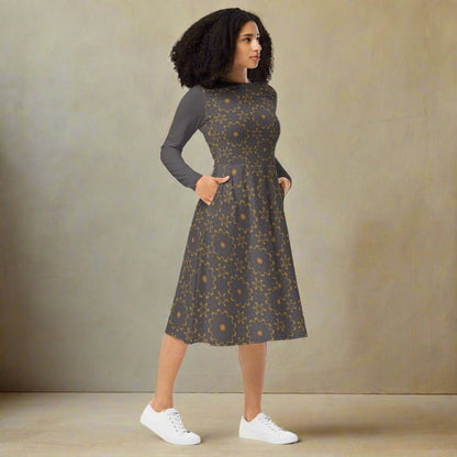 Woman wearing a patterned dress with a plain background