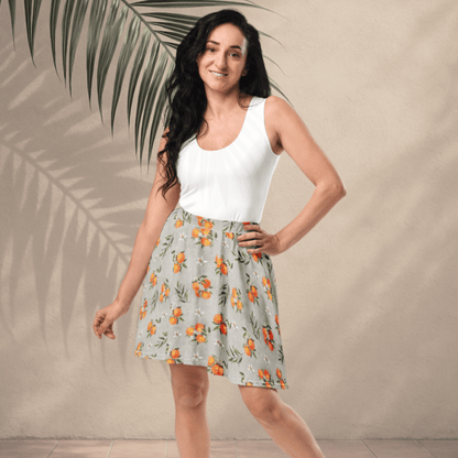 Woman wearing a white top and floral skirt with palm leaves in the background