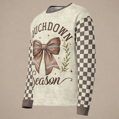 Sweater with 'Touchdown Season' design featuring a bow and football on a beige background