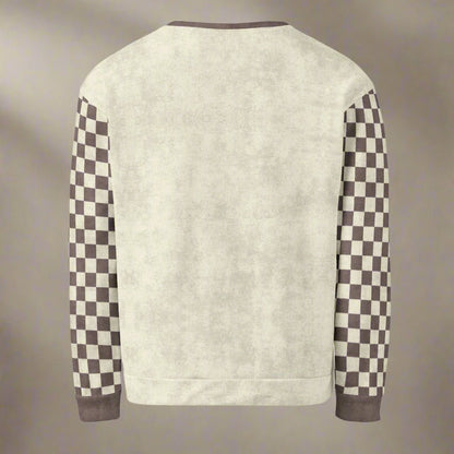 Beige sweater with checkered sleeves on a beige background