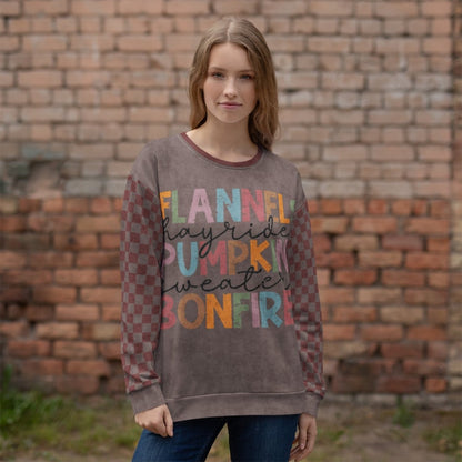 Woman wearing a burgundy and espresso sweatshirt with text in front of a brick wall
