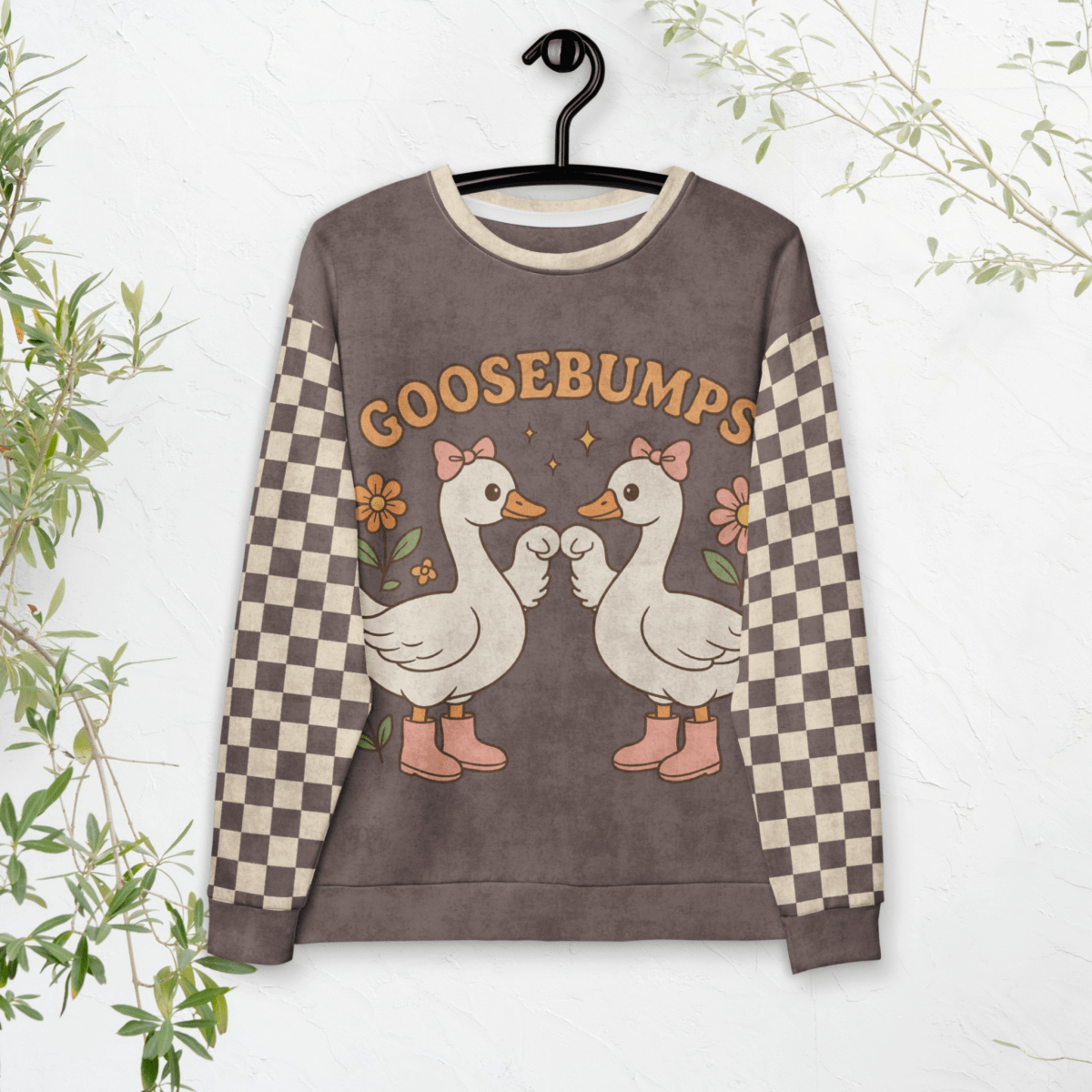 Sweatshirt with cartoon geese and 'GOOSEBUMPS' text on a hanger against a white background.