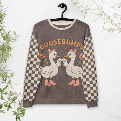 Sweatshirt with cartoon geese and 'GOOSEBUMPS' text on a hanger against a white background.