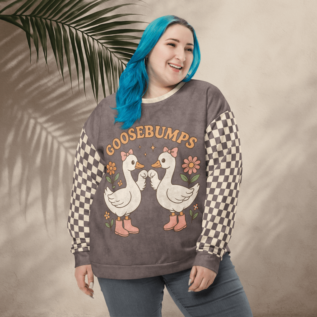 Person wearing a sweater with goose graphic and 'GOOSEBUMPS' text against a leafy background