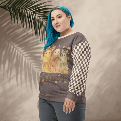 Person wearing a sweatshirt with ghost design and checkered sleeves against a beige background