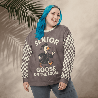 Woman wearing a sweater with 'Senior Goose on the Loose' design against a beige background