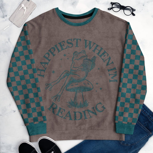 Espresso and teal Sweatshirt with checkered sleeves and Frog reading with "Happiest When I'm Reading"  design on a marble surface