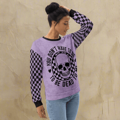 Woman wearing a purple sweatshirt with a skull design and text on a white background