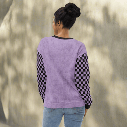 Person wearing a purple sweatshirt with checkered sleeves on a neutral background