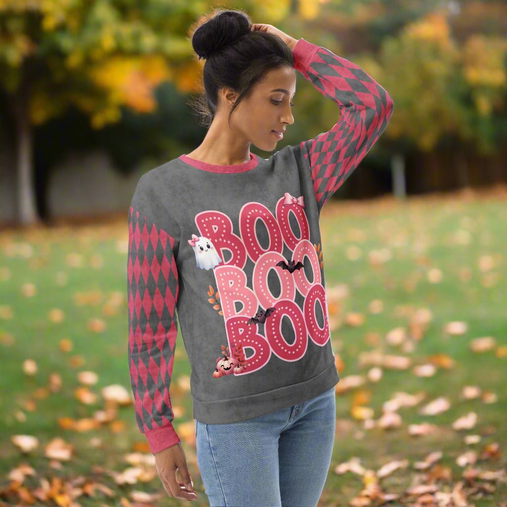 Woman wearing a gray sweatshirt with 'BOO BOO' text and graphic design on a white background