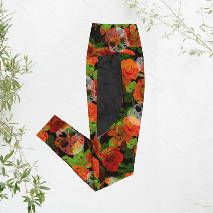 Colorful floral and skull patterned leggings on a white background with green leaves.
