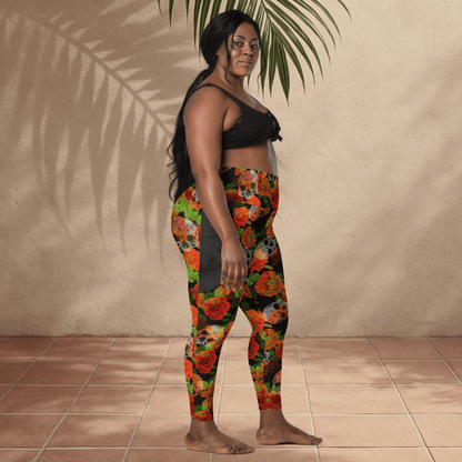 Woman wearing colorful floral skull leggings and a black top against a beige wall.