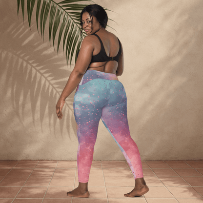 Woman wearing colorful leggings with a gradient design, standing against a beige wall.