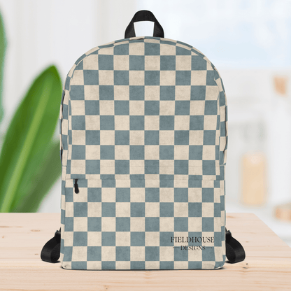 Checkered backpack with 'Fieldhouse Designs' branding on a wooden surface.
