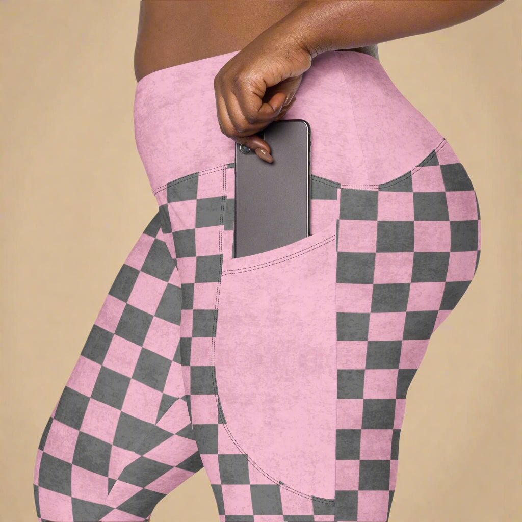 close up photo of model wearing Pink Checkered Print High-Waisted UPF 50+ Pocket Leggings 2XS–6XL, placing her phone in to the deep side pocket