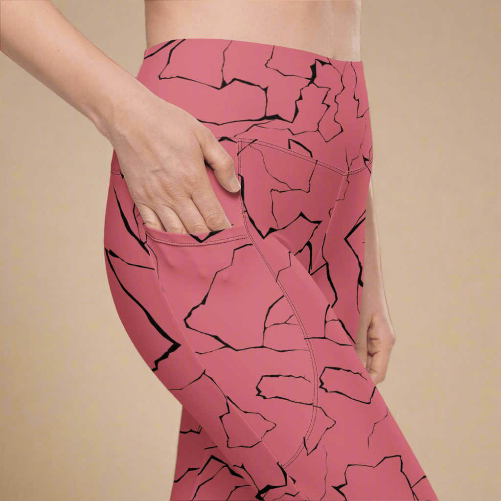Pink leggings with black abstract pattern worn by a person on a beige background