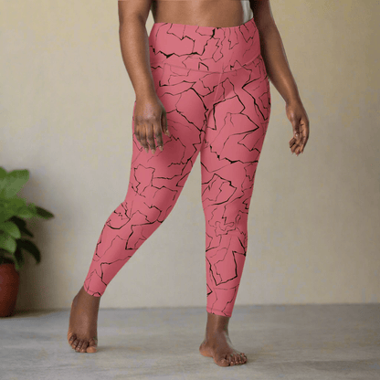 Person wearing pink leggings with black abstract pattern in a minimal indoor setting