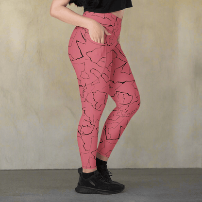Pink leggings with black abstract pattern worn by a person on a neutral background