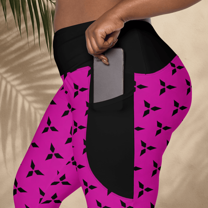 Person wearing pink leggings with black patterns and a pocket, holding a phone.