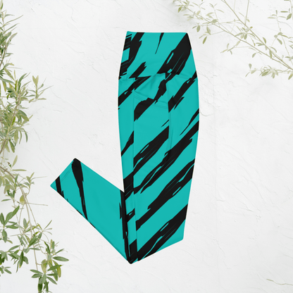 Teal and black tiger stripe patterned leggings on a white background with green leaves.