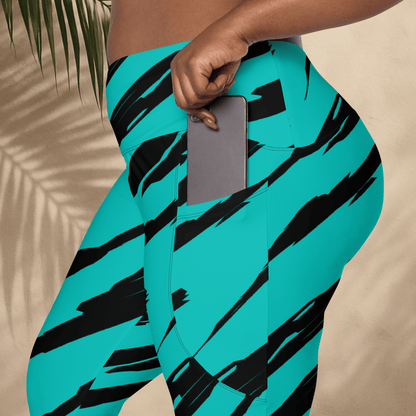Person wearing teal leggings with black tiger stripe patterns, holding a phone in a pocket.