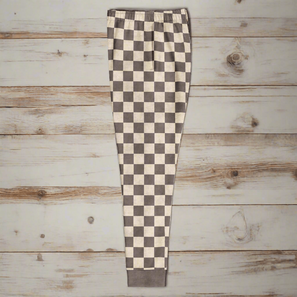 Checkered pants with brown and white pattern on a wood background