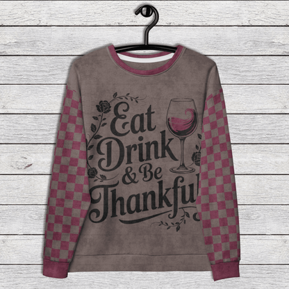 Checkered sleeve crewneck Sweatshirt with 'Eat Drink & Be Thankful' text and wine glass graphic on a wooden background 