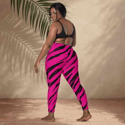 Person wearing pink and black tiger striped pants against a beige wall.