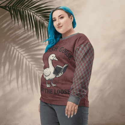 Person wearing a sweatshirt with a goose graphic and text against a beige background