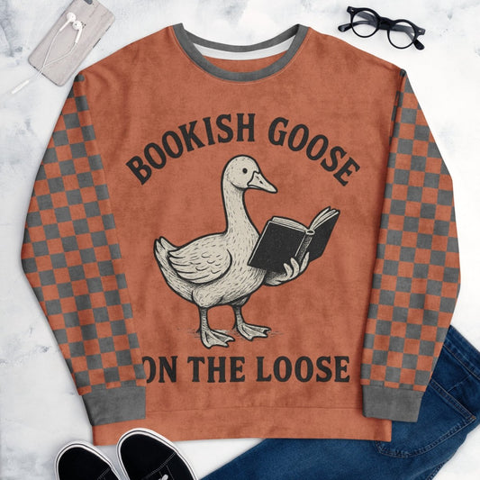 Sweatshirt with a goose holding a book and text 'Bookish Goose on the Loose' with a checkered sleeve design.
