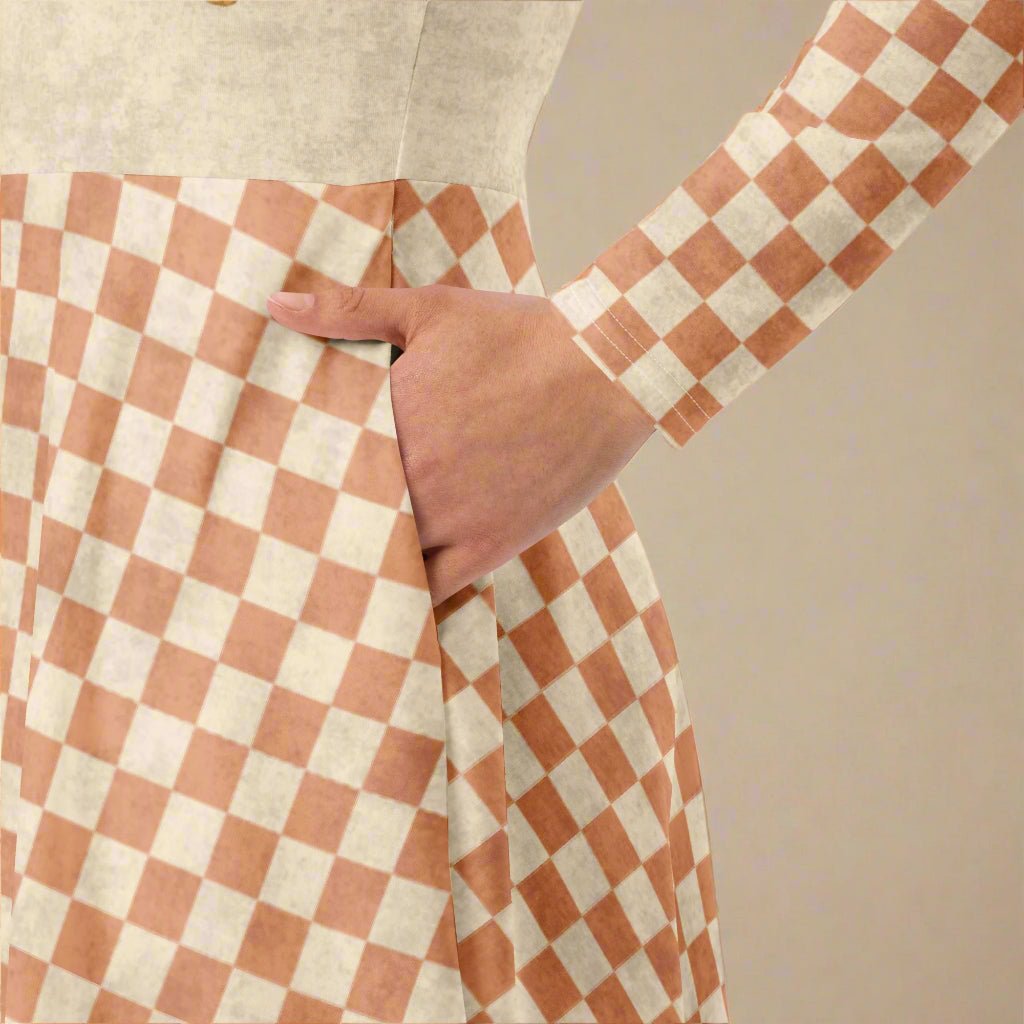 Person wearing a checkered dress with a beige background