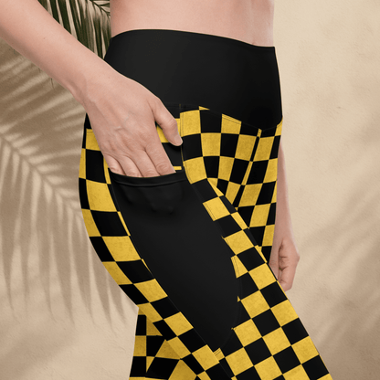 Person wearing black and yellow checkered pants on a beige background
