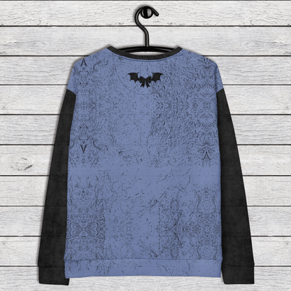 Blue long-sleeve shirt with black accents on a wooden surface