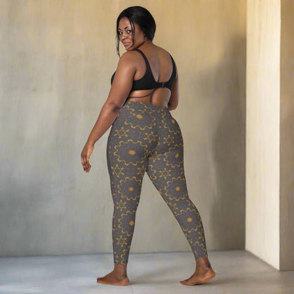 Woman wearing gray leggings with a geometric pattern on a neutral background