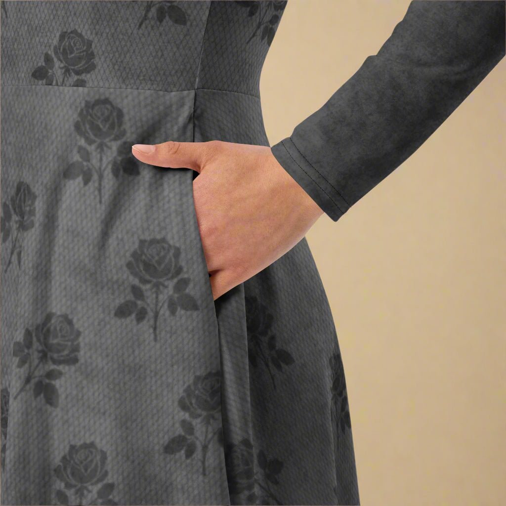 Gray dress with floral pattern and a hand in the pocket against a beige background