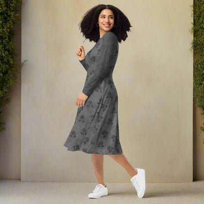 Woman wearing a gray floral dress with white sneakers against a beige wall.